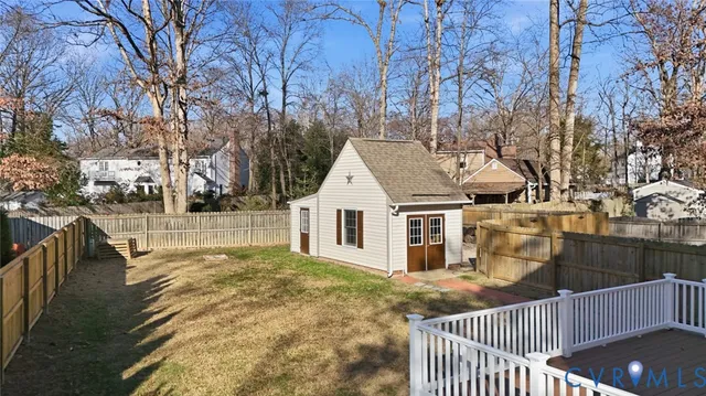 a view of a house with a wooden fence