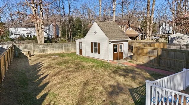 a view of residential house with wooden fence