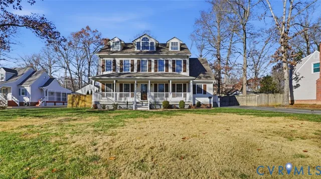 a view of a big house with a big yard and large trees