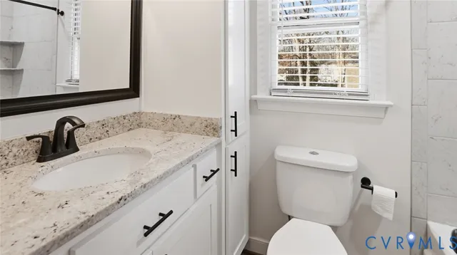 a bathroom with a bath tub with a shower