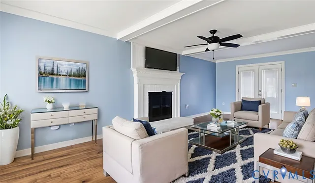 a living room with furniture a fireplace and a flat screen tv