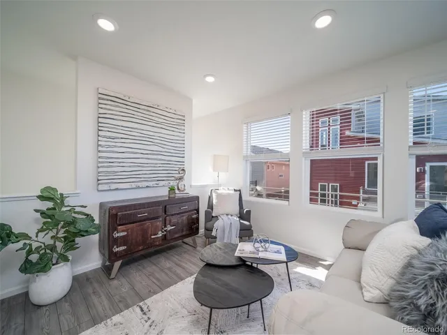 a living room with furniture and a potted plant