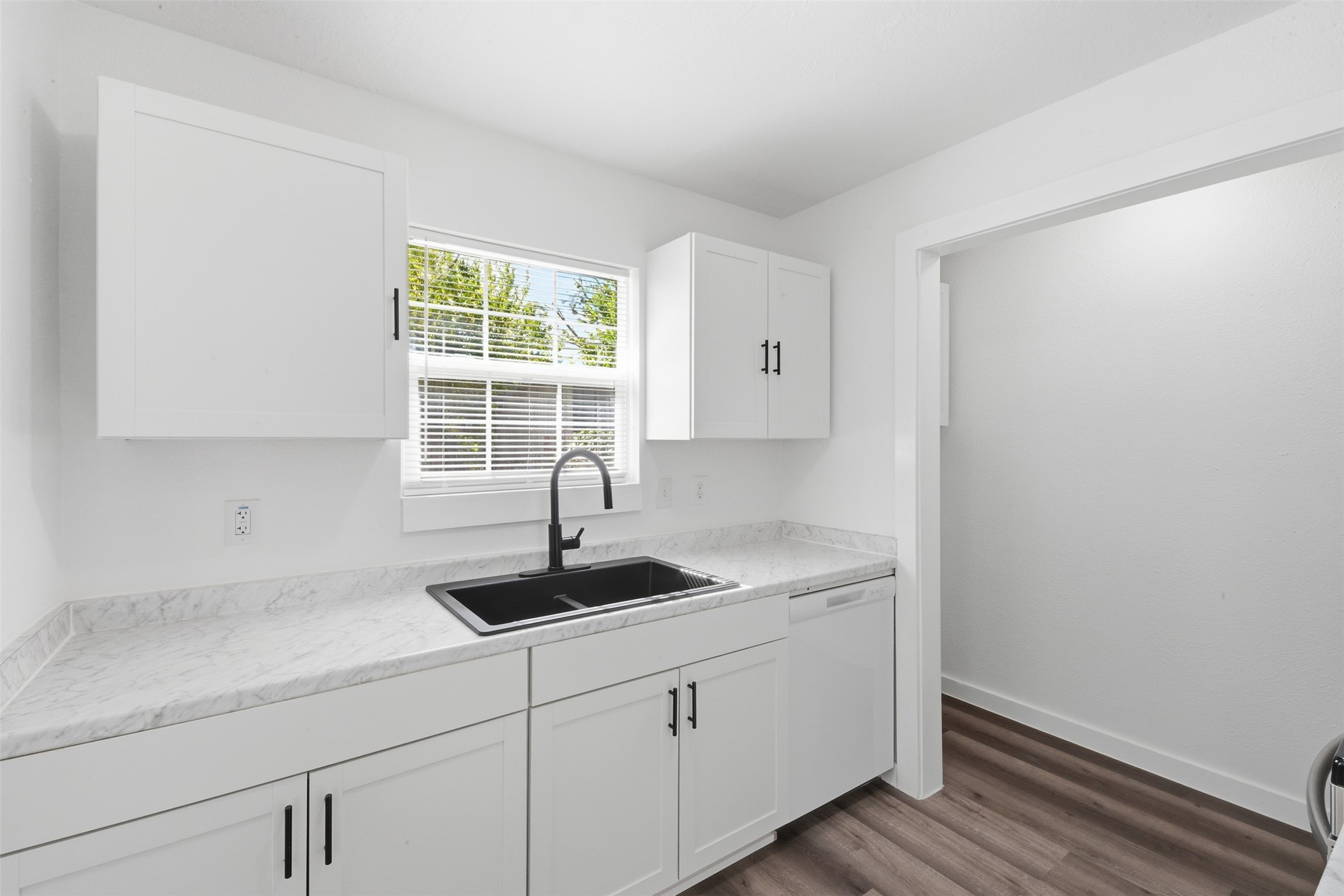 111 Calvin Street Pasadena, TX 77506 - Photo 12 of 40 a kitchen with a sink and cabinets
