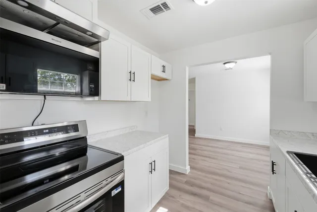 a view of kitchen island with wooden floor