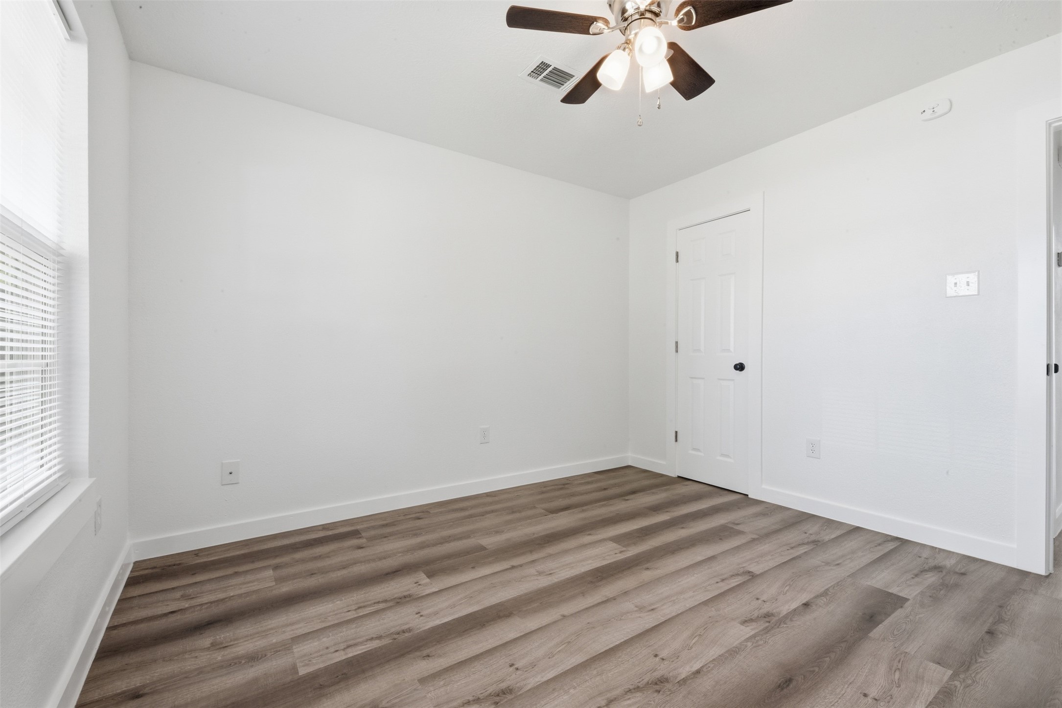 111 Calvin Street Pasadena, TX 77506 - Photo 18 of 40 a view of room with hardwood floor and ceiling fan