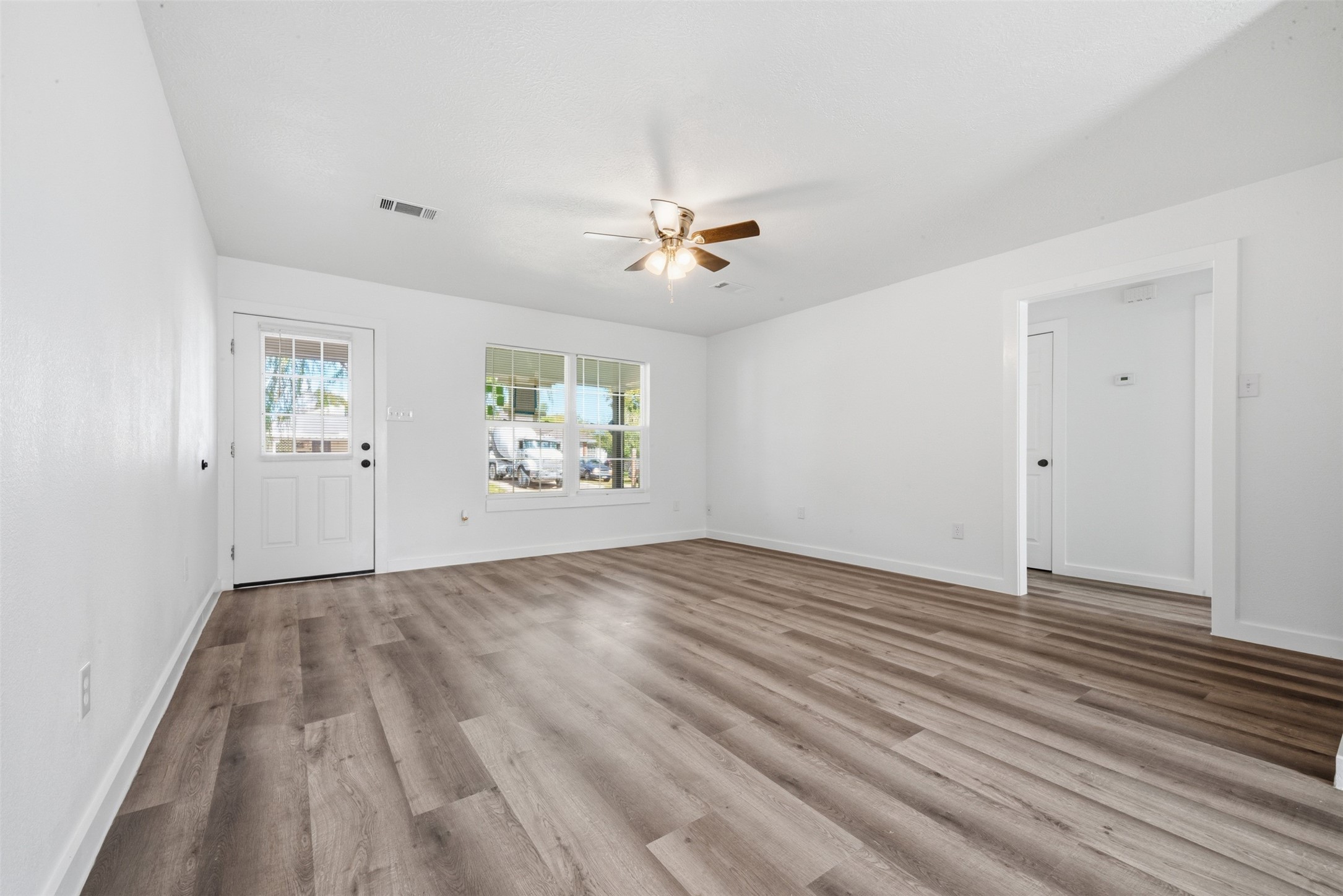 111 Calvin Street Pasadena, TX 77506 - Photo 5 of 40 wooden floor in an empty room with a window