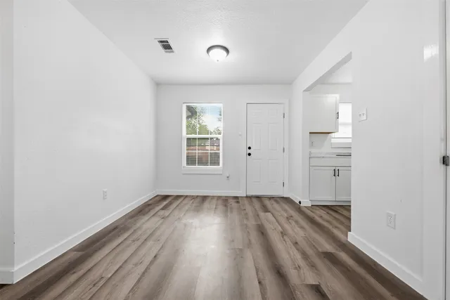wooden floor in an empty room with a window