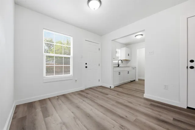 an empty room with windows and entrance