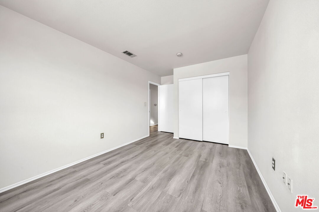 820 West Compton Boulevard, Unit 17 Compton, CA 90220 - Photo 31 of 50 a view of an empty room with wooden floor