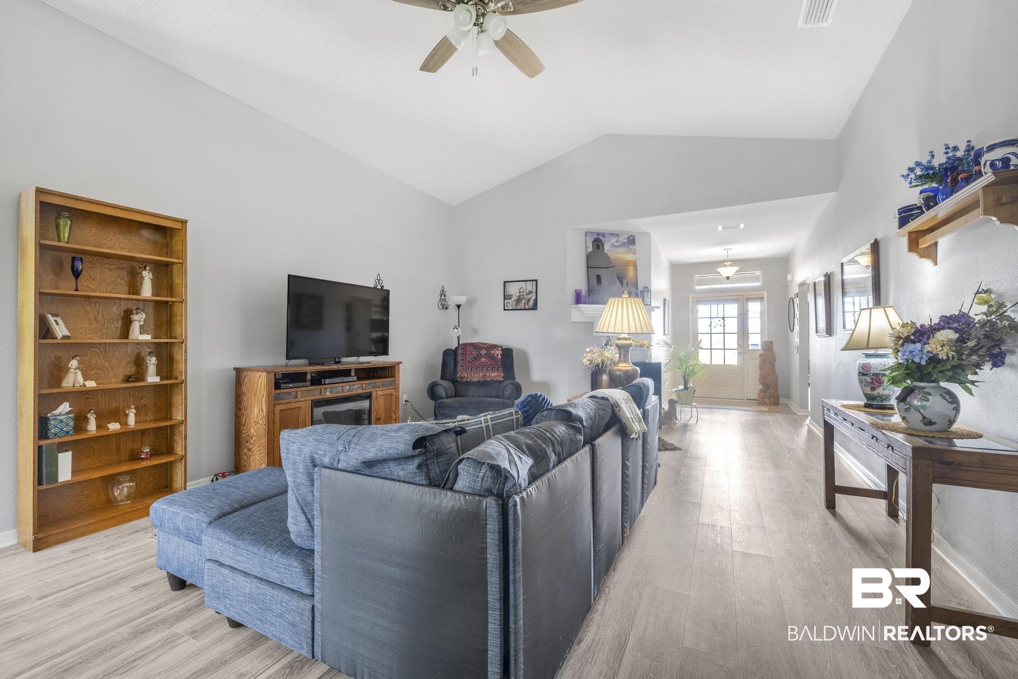 16545 Cold Mill Loop Foley, AL 36535 - Photo 8 of 48 Living room featuring a ceiling fan, lofted ceiling, light wood-type flooring, baseboards, and visible vents
