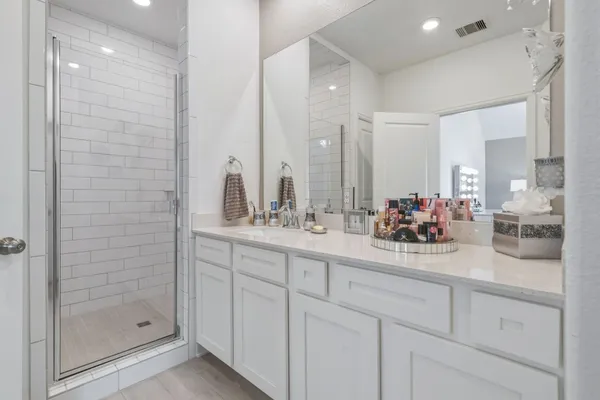 a bathroom with double sink and a mirror