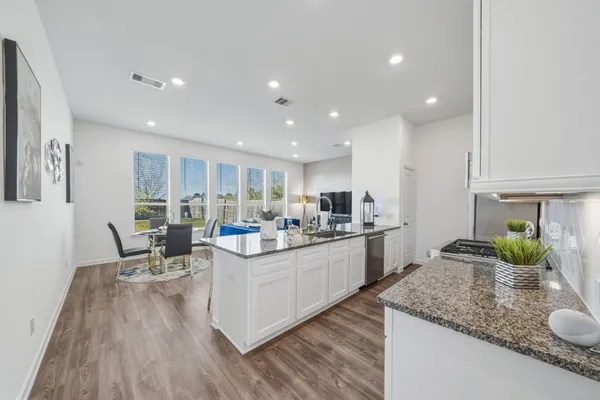 a kitchen with sink cabinets and wooden floor