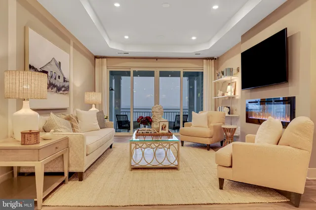 a living room with fireplace furniture and a flat screen tv