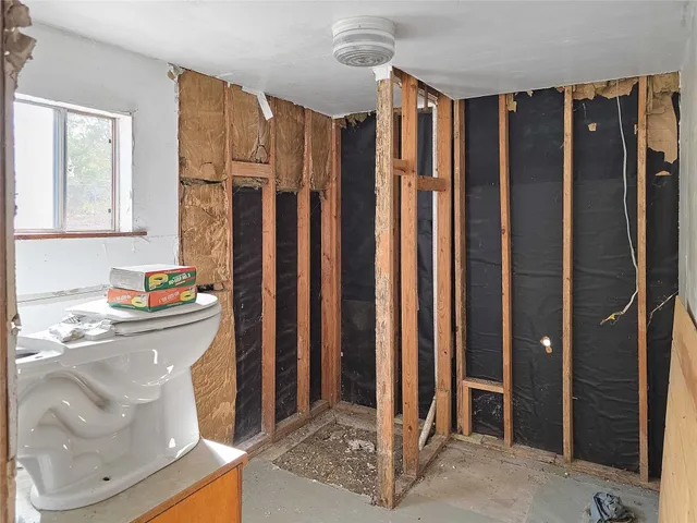 a view of a bathroom with tub and shower