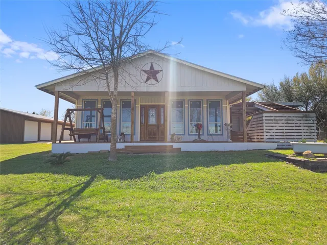 a view of a house with swimming pool and a yard