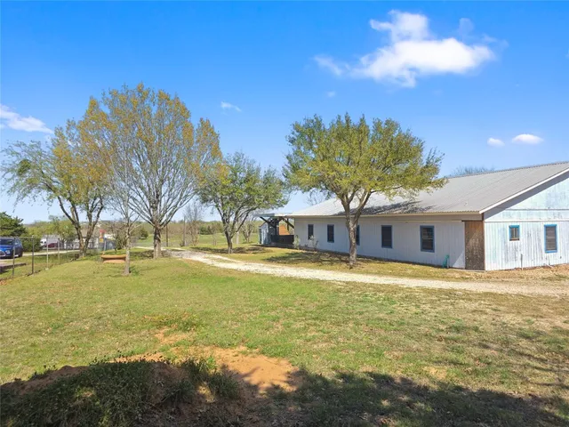 a view of a house with a yard and ocean view