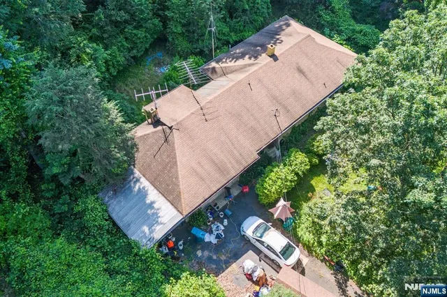 an aerial view of a house with a yard and garden