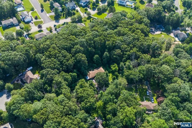 an aerial view of a house with a yard and outdoor seating