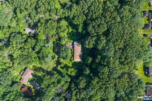 a backyard of a house with lots of green space and tub