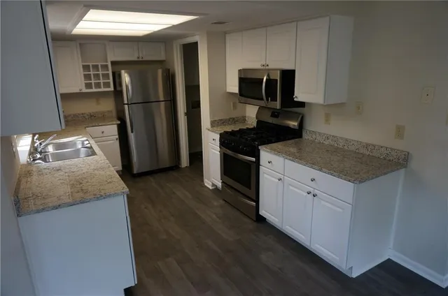 a kitchen with a refrigerator stove and microwave