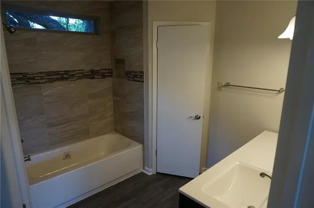 a bathroom with a tub and a shower