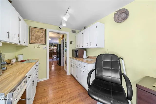a kitchen with cabinets and appliances