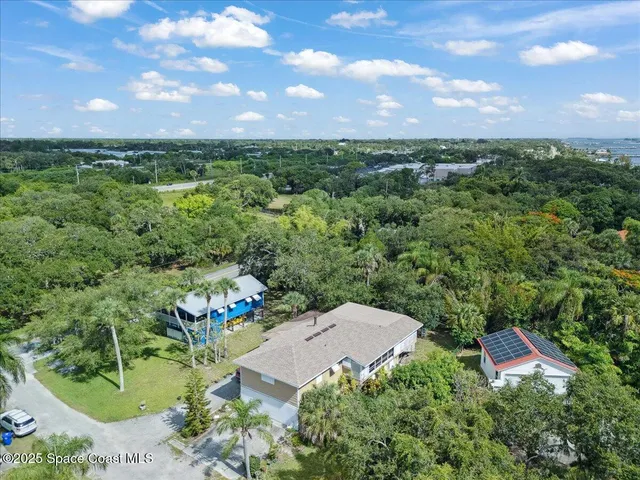 an aerial view of a house with a yard