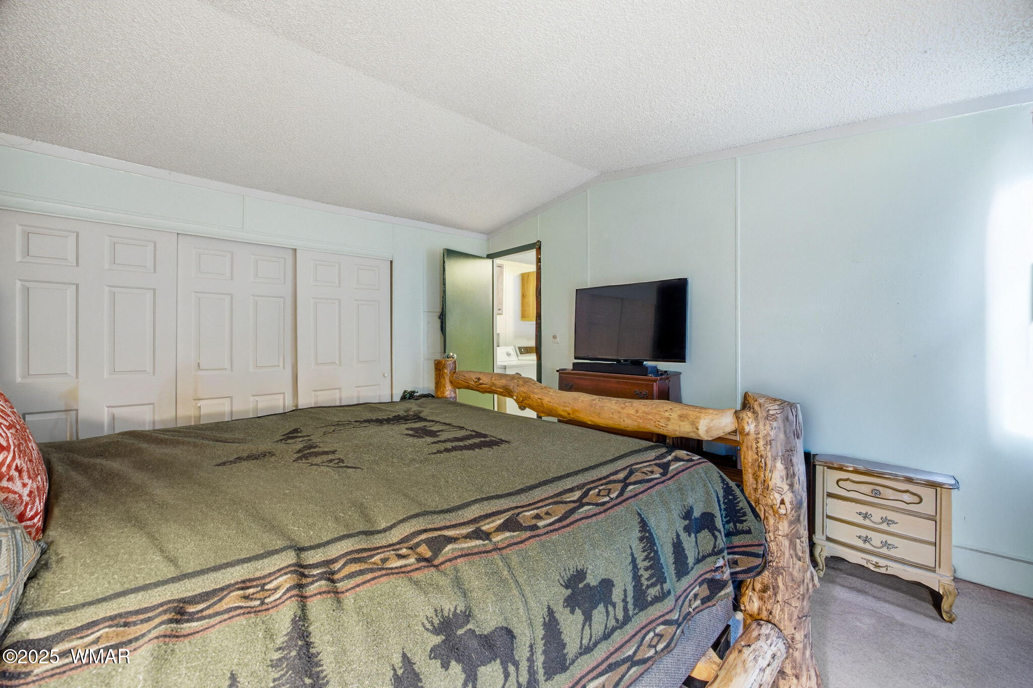 703 East Frontier Street, Unit 31 Payson, AZ 85541 - Photo 10 of 21 a bedroom with a bed and a flat screen tv