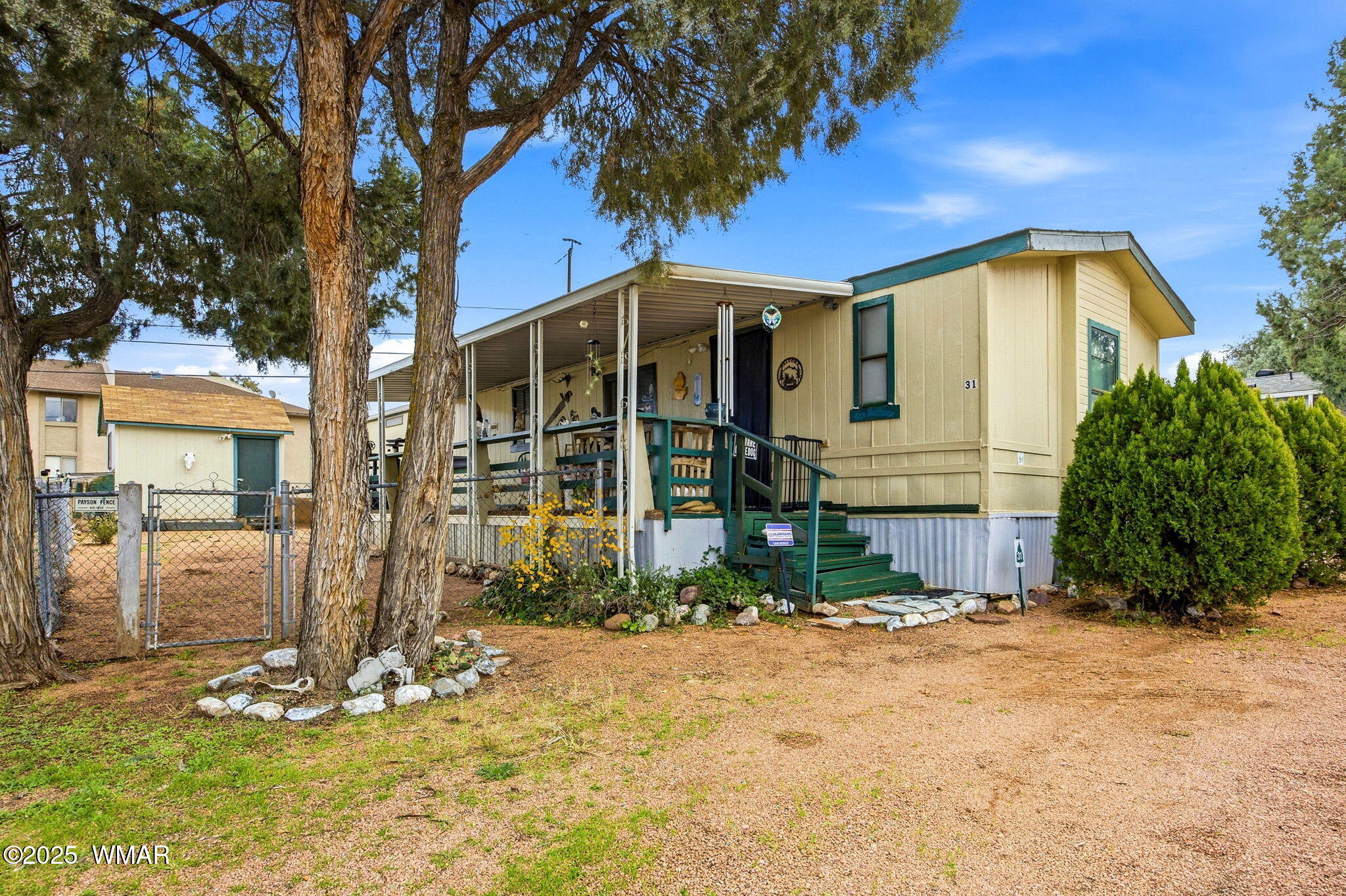 703 East Frontier Street, Unit 31 Payson, AZ 85541 - Photo 1 of 21 a front view of a house with garden