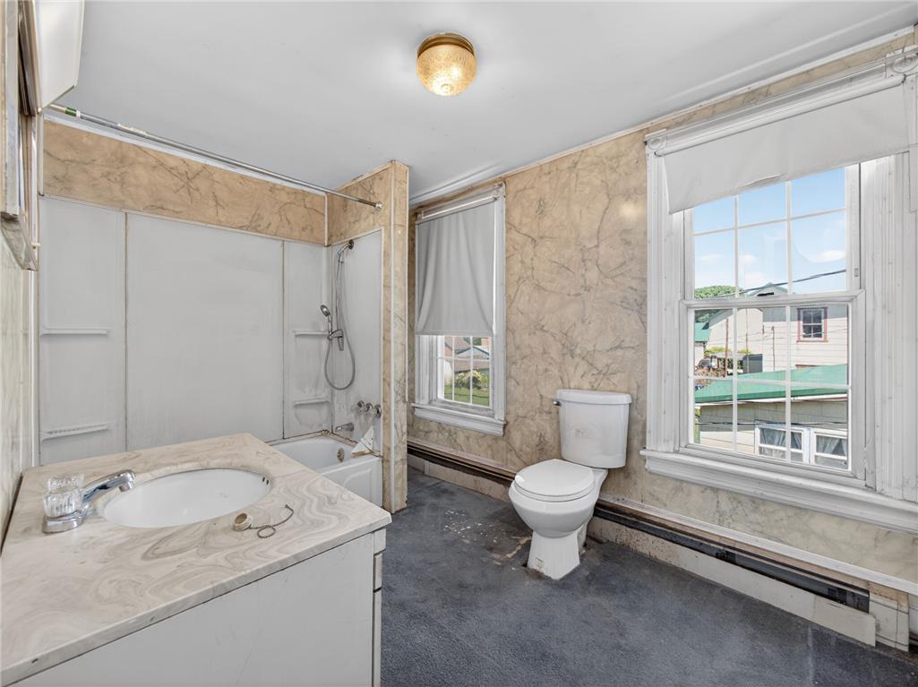 15845 Kutztown Road Mertztown, PA 19539 - Photo 17 of 24 Step into a generously proportioned bathroom featuring a vanity, tub with shower, and multiple windows.