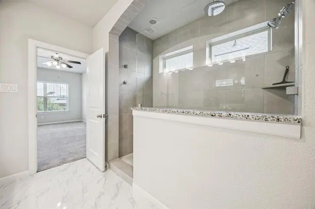 a view of a bathroom with a glass shower door