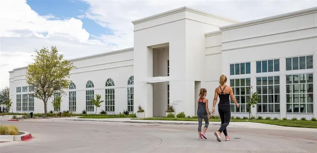 a view of a brick building next to a yard