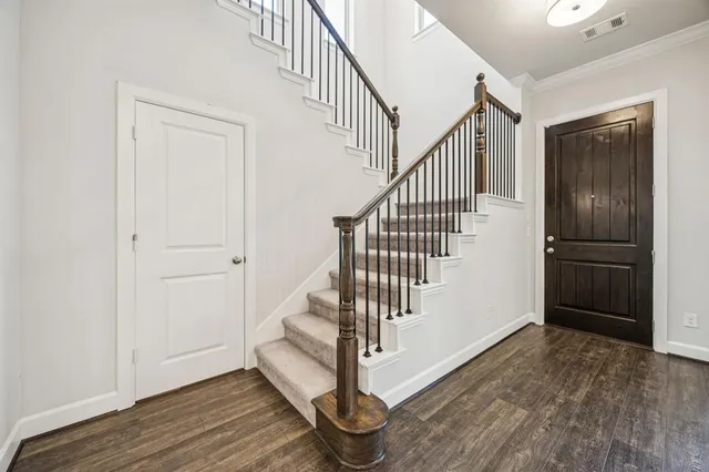 a view of entryway and hall with wooden floor