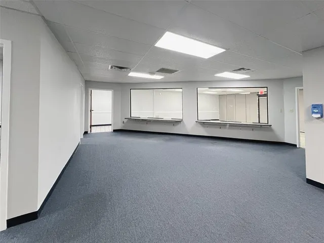 an empty room with a empty space and windows