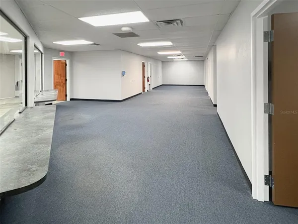 a view of a hallway with seating area
