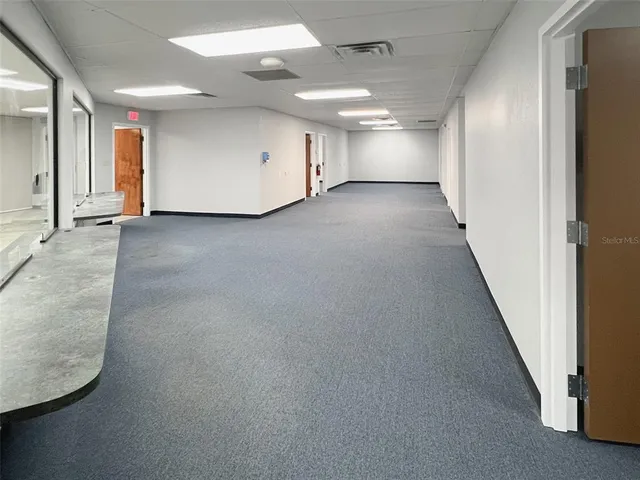 a view of a hallway with seating area