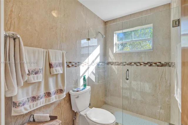 a white toilet sitting next to a bathroom sink