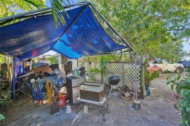 a view of a patio with table and chairs under an umbrella