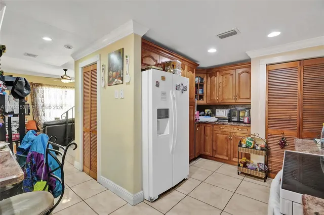 a kitchen with stainless steel appliances granite countertop a refrigerator and a stove