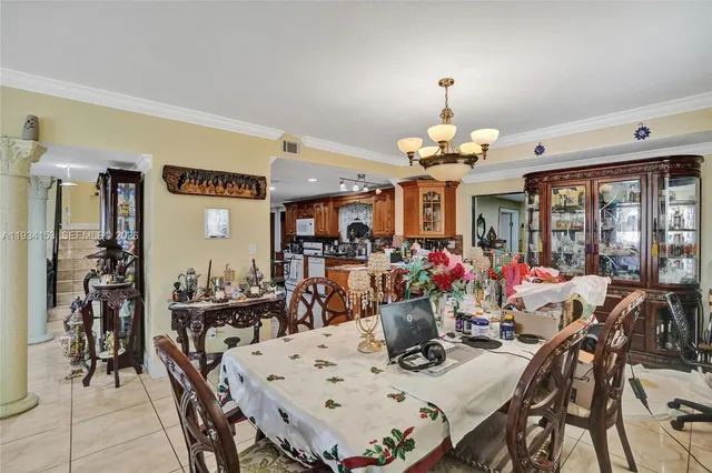 a view of a dining room with furniture and chandelier