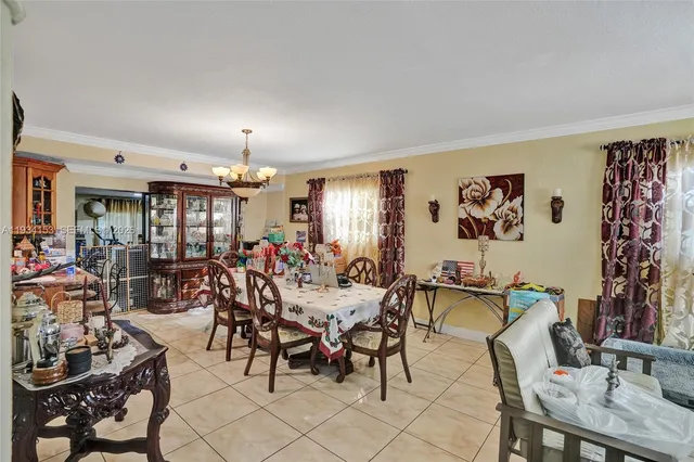 a room with lots of furniture and a potted plant