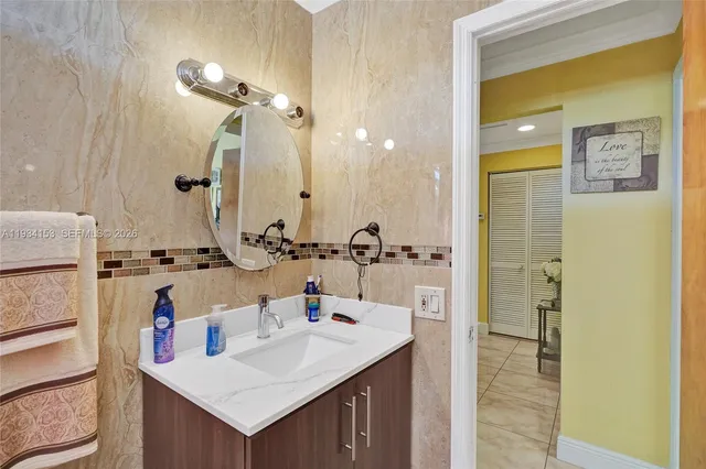 a bathroom with a sink vanity and a mirror