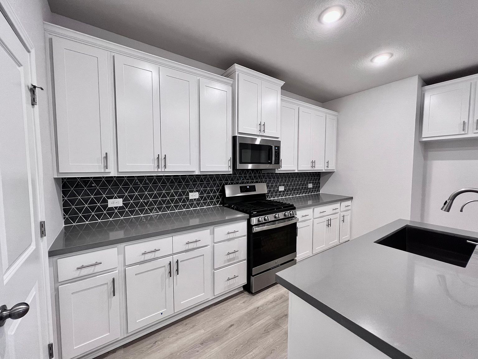 4701 Lavender Field Path, Unit 186 Austin, TX 78723 - Photo 11 of 29 a kitchen with granite countertop white cabinets and stainless steel appliances