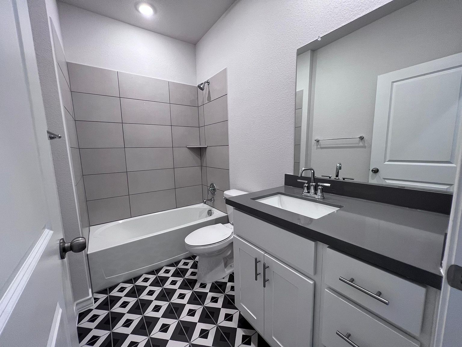 4701 Lavender Field Path, Unit 186 Austin, TX 78723 - Photo 13 of 29 a bathroom with a sink a toilet a mirror and shower