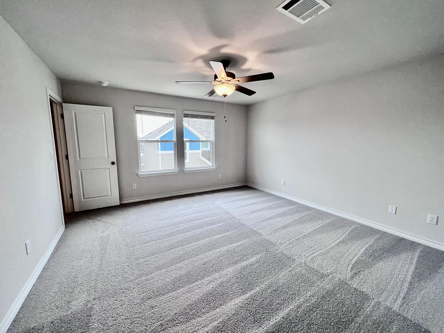 4701 Lavender Field Path, Unit 186 Austin, TX 78723 - Photo 16 of 29 an empty room with windows and ceiling fan