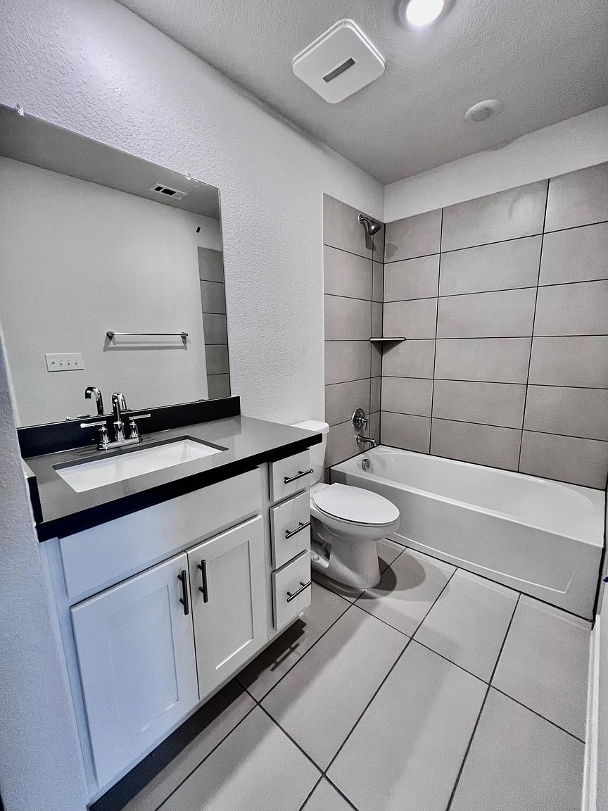 4701 Lavender Field Path, Unit 186 Austin, TX 78723 - Photo 25 of 29 a bathroom with a double vanity sink and a bathtub
