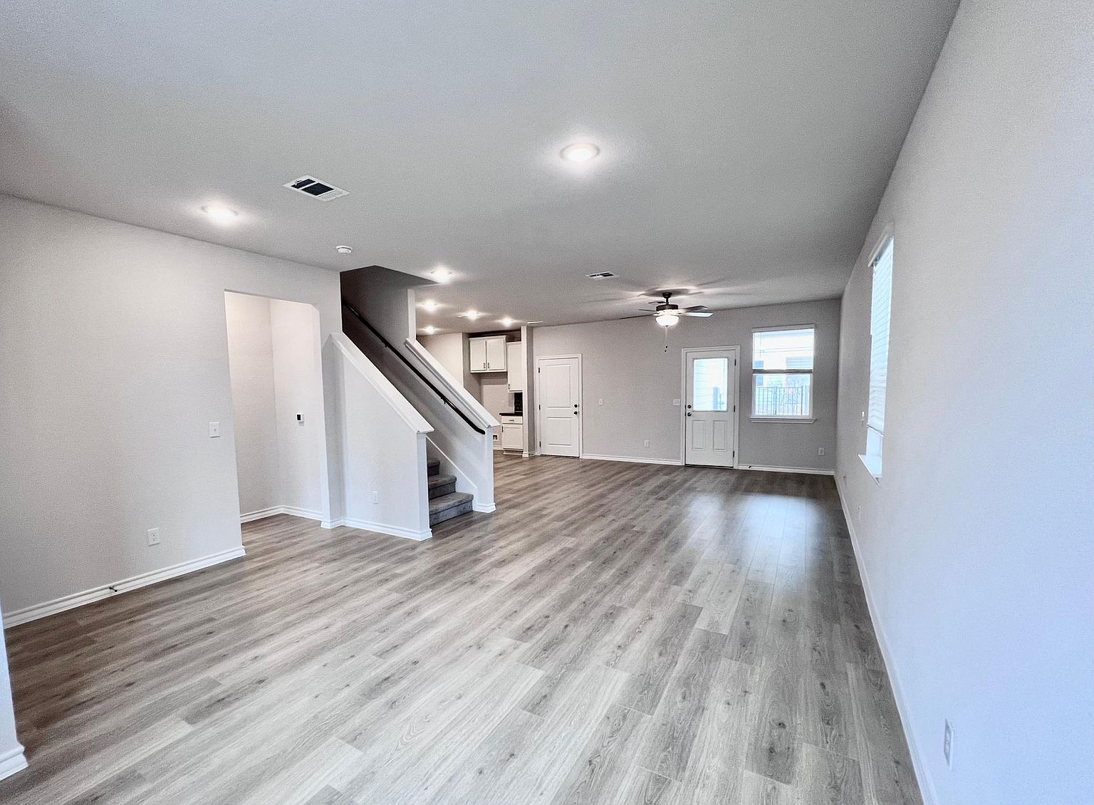 4701 Lavender Field Path, Unit 186 Austin, TX 78723 - Photo 4 of 29 a view of an empty room with wooden floor and a window