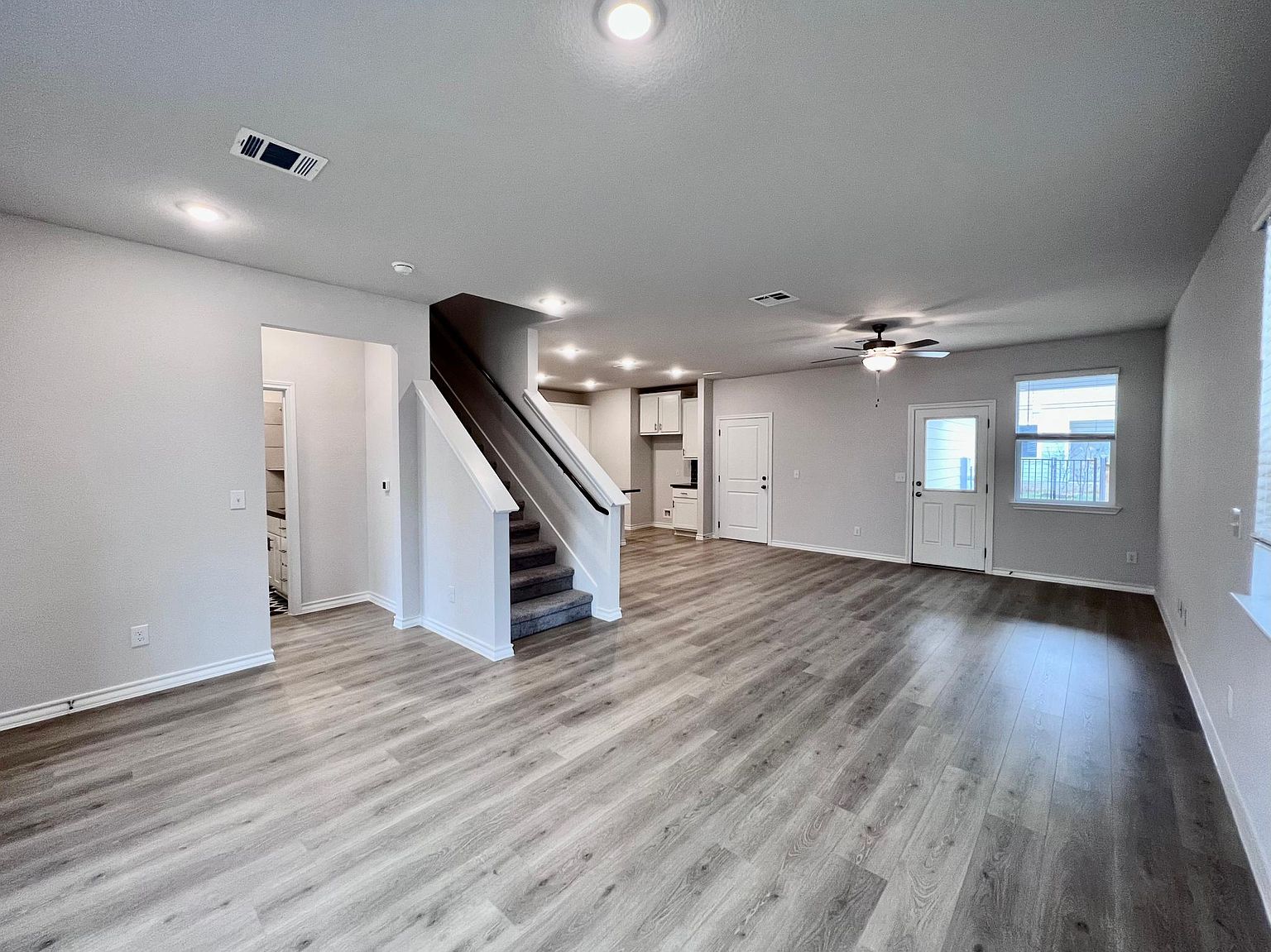 4701 Lavender Field Path, Unit 186 Austin, TX 78723 - Photo 5 of 29 a view of an empty room with wooden floor and stairs
