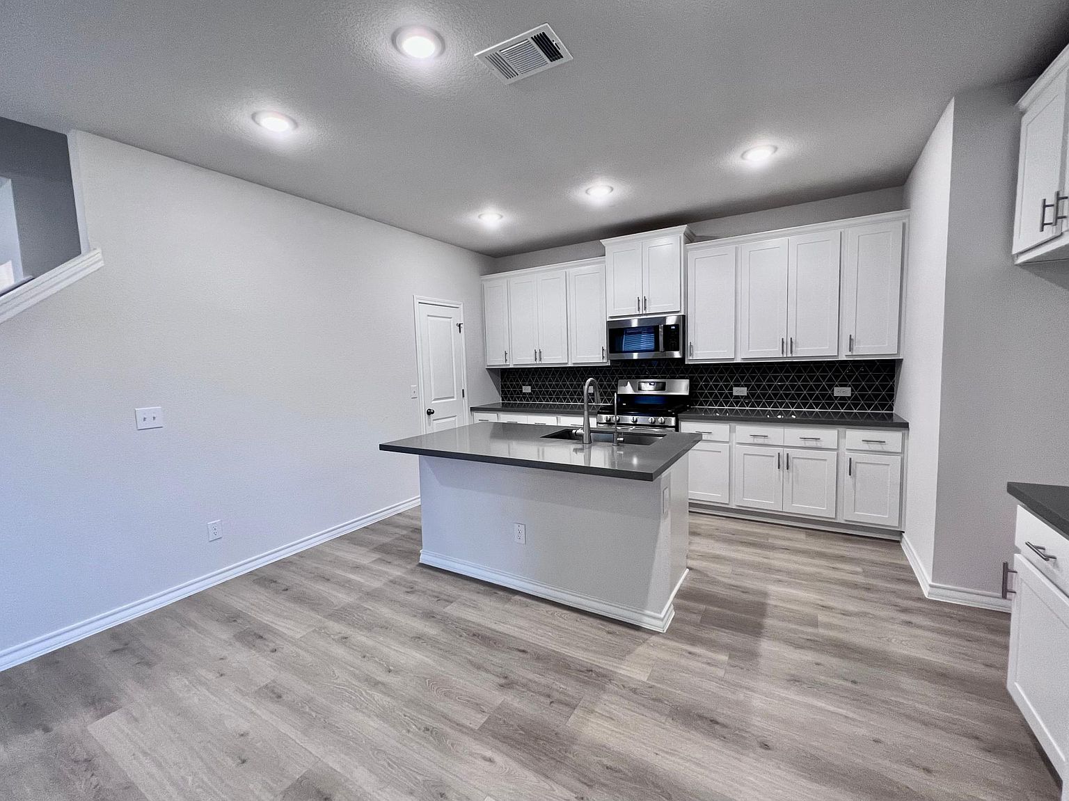 4701 Lavender Field Path, Unit 186 Austin, TX 78723 - Photo 8 of 29 a kitchen with stainless steel appliances granite countertop a stove a sink and white cabinets