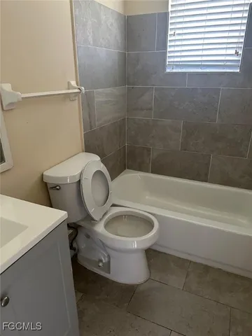a bathroom with a toilet and a bathtub